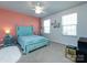 Bedroom featuring bright coral walls, blue furnishings, and natural light from large windows at 2018 Sewall Sw Ave, Concord, NC 28025