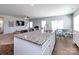 Open-concept kitchen with granite countertops, stainless steel sink, and view into living room at 2018 Sewall Sw Ave, Concord, NC 28025
