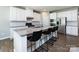 Kitchen with white cabinets, stainless steel appliances, granite countertops, and a breakfast bar at 2018 Sewall Sw Ave, Concord, NC 28025
