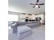 Open-concept living room and kitchen with a large gray sectional couch and breakfast bar at 2018 Sewall Sw Ave, Concord, NC 28025