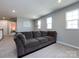 This living room features recessed lighting, large windows, neutral walls, and a comfortable sofa at 2018 Sewall Sw Ave, Concord, NC 28025