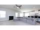 Spacious living room featuring a fireplace, ceiling fan, and a large sectional sofa at 2018 Sewall Sw Ave, Concord, NC 28025