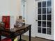 Office space with white trim, light wood floors, and a glass paneled door that provides natural light at 2018 Sewall Sw Ave, Concord, NC 28025