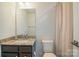 Bathroom featuring a granite vanity, new lighting, framed mirror, and tile flooring at 224 Parkwood Ave, Charlotte, NC 28206