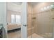 Modern bathroom with tiled shower and glass door conveniently located near the bedroom space at 224 Parkwood Ave, Charlotte, NC 28206
