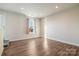 Large bonus room with hardwood flooring and a window providing natural light at 224 Parkwood Ave, Charlotte, NC 28206