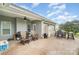 Covered back patio with comfortable seating and an outdoor grill, ideal for relaxation and entertaining at 2408 Joes Lake Rd, Shelby, NC 28152