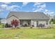 Charming backyard with a patio, outdoor seating, and a well-maintained lawn, perfect for outdoor relaxation at 2408 Joes Lake Rd, Shelby, NC 28152