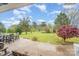 Expansive backyard with patio, manicured lawn, established trees, and stepping stones, perfect for outdoor living at 2408 Joes Lake Rd, Shelby, NC 28152