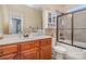 Bathroom featuring a single sink vanity with wood cabinets, a toilet, and a shower/tub with sliding glass doors at 2408 Joes Lake Rd, Shelby, NC 28152