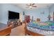 Inviting bedroom with a decorative bed frame and television, complemented by neutral carpeting and natural light at 2408 Joes Lake Rd, Shelby, NC 28152