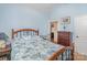 Comfortable bedroom with light blue walls, large bed with blue patterned bedding, and access to an adjacent room at 2408 Joes Lake Rd, Shelby, NC 28152