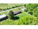 Aerial view of a blue house with a big backyard surrounded by trees, perfect for Gathering activities at 2430 Rocky Ford Rd, Newton, NC 28658