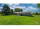 Spacious backyard with lush green grass, patio, and a privacy fence at 2430 Rocky Ford Rd, Newton, NC 28658