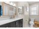 Charming bathroom with black vanity, white countertops, decorative mirrors, and a window at 2430 Rocky Ford Rd, Newton, NC 28658