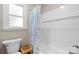 Clean bathroom featuring a tiled shower, white fixtures, and a window for natural light at 2430 Rocky Ford Rd, Newton, NC 28658