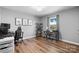 Functional office area with hardwood floors, a comfortable desk, and natural light from the window at 2430 Rocky Ford Rd, Newton, NC 28658