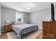 Comfortable bedroom featuring hardwood floors, a decorative rug, and a large window for natural light at 2430 Rocky Ford Rd, Newton, NC 28658