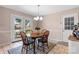 Eat-in kitchen features a wood table, bright light fixture, and backyard access at 2430 Rocky Ford Rd, Newton, NC 28658