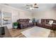 Inviting living room featuring hardwood floors, a ceiling fan, and comfortable leather sofas at 2430 Rocky Ford Rd, Newton, NC 28658
