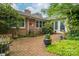 Beautiful brick patio surrounded by lush greenery with comfortable seating and well-placed potted plants at 2515 Sheffield Dr, Gastonia, NC 28054