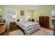 Well-lit bedroom with hardwood floors, vintage furniture and decor, and two windows at 2515 Sheffield Dr, Gastonia, NC 28054
