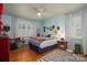 Bright bedroom featuring a ceiling fan, hardwood floors, and ample natural light from two windows at 2515 Sheffield Dr, Gastonia, NC 28054