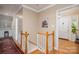 Hallway features wood railing and access to the front door at 2515 Sheffield Dr, Gastonia, NC 28054