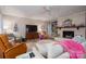 Cozy living room with ceiling fan, brick fireplace, built-in shelving, and neutral decor at 2515 Sheffield Dr, Gastonia, NC 28054