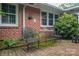 Outdoor patio with brick walls, a metal table and chairs, plus lush greenery at 2515 Sheffield Dr, Gastonia, NC 28054