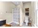 Bright bathroom with a shower, tiled floors, vanity, toilet, and decorative wall art at 2569 Lower Assembly Dr, Fort Mill, SC 29708