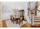 Formal dining room with hardwood floors, wainscoting, and a modern chandelier at 2569 Lower Assembly Dr, Fort Mill, SC 29708