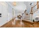 Elegant foyer featuring hardwood floors, a staircase, and an open floor plan at 2569 Lower Assembly Dr, Fort Mill, SC 29708