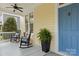 Inviting front porch with rocking chairs and a blue front door at 2569 Lower Assembly Dr, Fort Mill, SC 29708