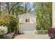 Detached garage with white doors and trim, situated near lush landscaping at 2569 Lower Assembly Dr, Fort Mill, SC 29708
