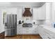 Gourmet kitchen featuring stainless steel refrigerator and a custom wood range hood at 2569 Lower Assembly Dr, Fort Mill, SC 29708