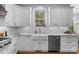 Kitchen with farmhouse sink, stainless steel dishwasher and bright window at 2569 Lower Assembly Dr, Fort Mill, SC 29708