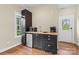 Efficient kitchenette with modern appliances, dark cabinetry, butcher block counter, and hardwood flooring at 2569 Lower Assembly Dr, Fort Mill, SC 29708