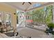 Charming porch overlooking lush greenery and a carriage house, ideal for serene relaxation at 2569 Lower Assembly Dr, Fort Mill, SC 29708