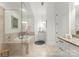 Bright bathroom featuring a glass shower, soaking tub, and white cabinetry at 2823 Providence Rd # 143, Charlotte, NC 28211