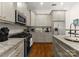 Well-equipped kitchen with stainless steel appliances, granite countertops, and custom cabinetry at 2823 Providence Rd # 143, Charlotte, NC 28211