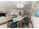 Spacious living and dining area with modern lighting and open flow to kitchen, perfect for gatherings at 2823 Providence Rd # 143, Charlotte, NC 28211