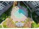 Aerial view of a uniquely shaped community pool with lounge chairs and meticulously landscaped surroundings at 2823 Providence Rd # 143, Charlotte, NC 28211