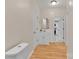 Bright bathroom with laminate flooring, white vanity, toilet, and gold accented mirror at 319 Chestnut St, Rock Hill, SC 29730