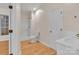 Neutral bathroom with laminate flooring, white shower, toilet, and vanity at 319 Chestnut St, Rock Hill, SC 29730