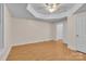 Bedroom featuring a tray ceiling, modern ceiling fan, and wood-look floors at 319 Chestnut St, Rock Hill, SC 29730