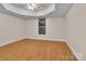 Bedroom featuring a tray ceiling, modern ceiling fan, and wood-look floors at 319 Chestnut St, Rock Hill, SC 29730