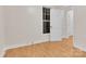 Bright bedroom features wood floors, a window, and a white door at 319 Chestnut St, Rock Hill, SC 29730