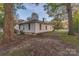 Exterior home view showcasing mature trees and well-kept lawn at 319 Chestnut St, Rock Hill, SC 29730