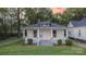 Picture-perfect home with a classic porch, beautiful landscaping, and a vibrant sunset backdrop at 319 Chestnut St, Rock Hill, SC 29730